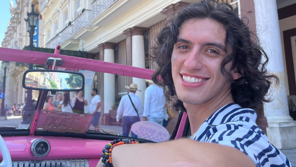 NC State Student Joshua Wasserman in a pink vintage car