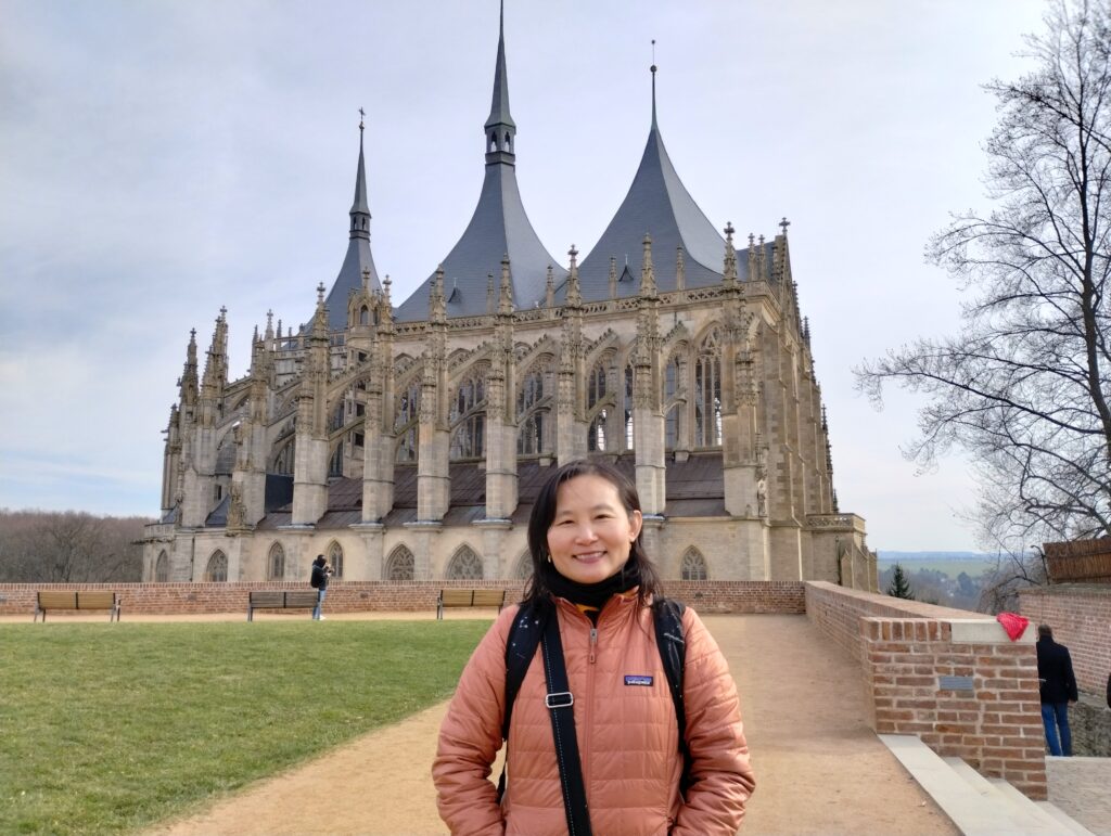 Dr. Alice Lee posing in from of the Church of St. Barbara in Kutná Hora, Czech Republic.