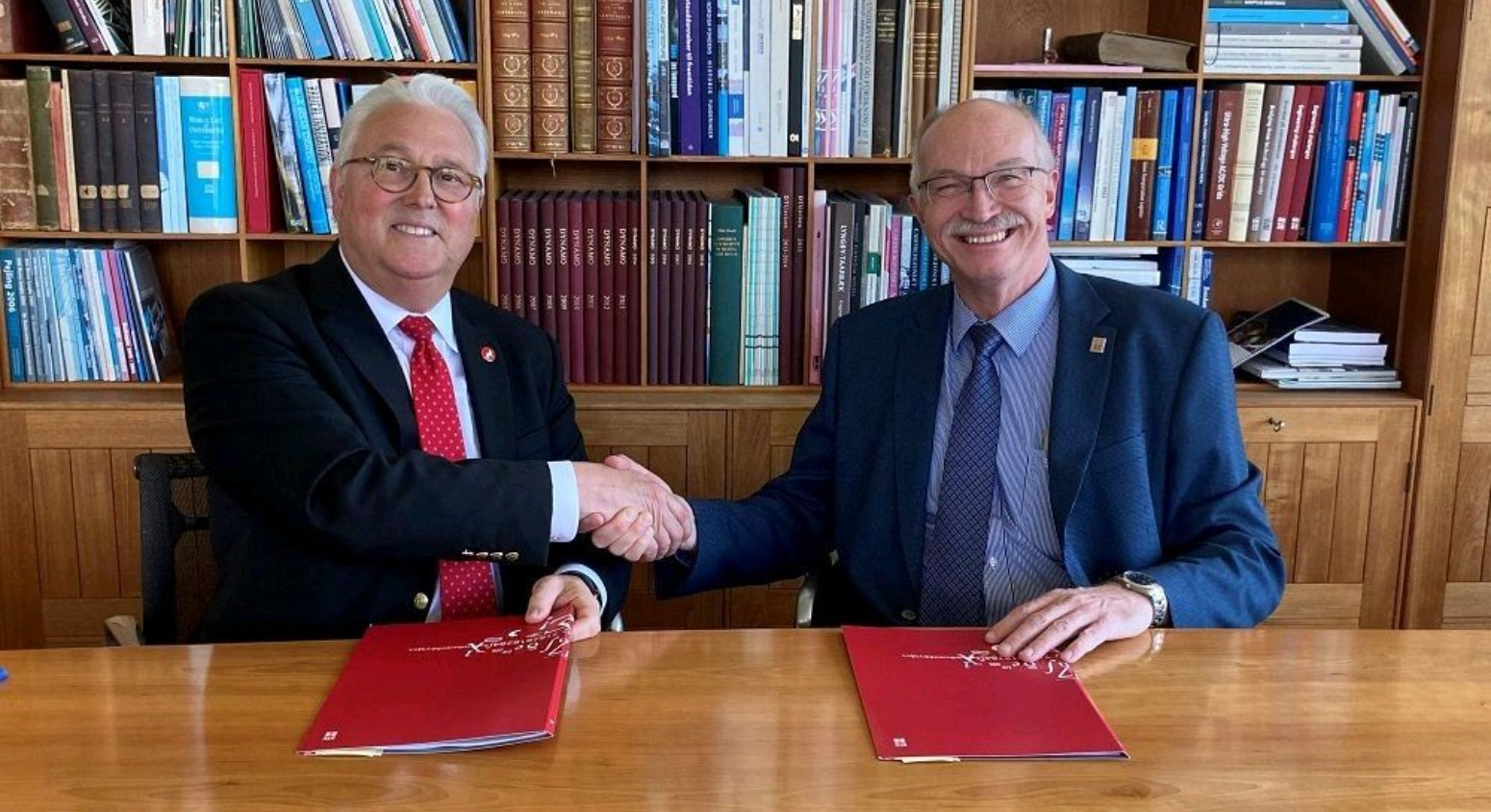 Chancellor Woodson (left) and DTU President Anders Bjarklev (right) shaking hands after signing strategic partnership agreement