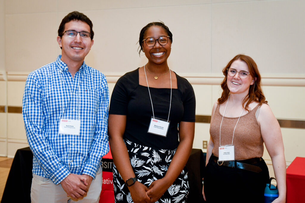 Nabih Dahik (left), Madison Sinclair (middle), and Ashton Croft (right) smiling for a group photo at the Global Engagement Expo.