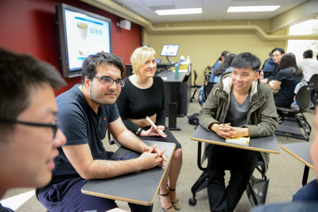 International students work in small groups in a classroom at the Intensive English program offices at NC State. Photo by Marc Hall