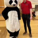 Bao Bao the Panda posing with Global Ambassador Grant McNaughton