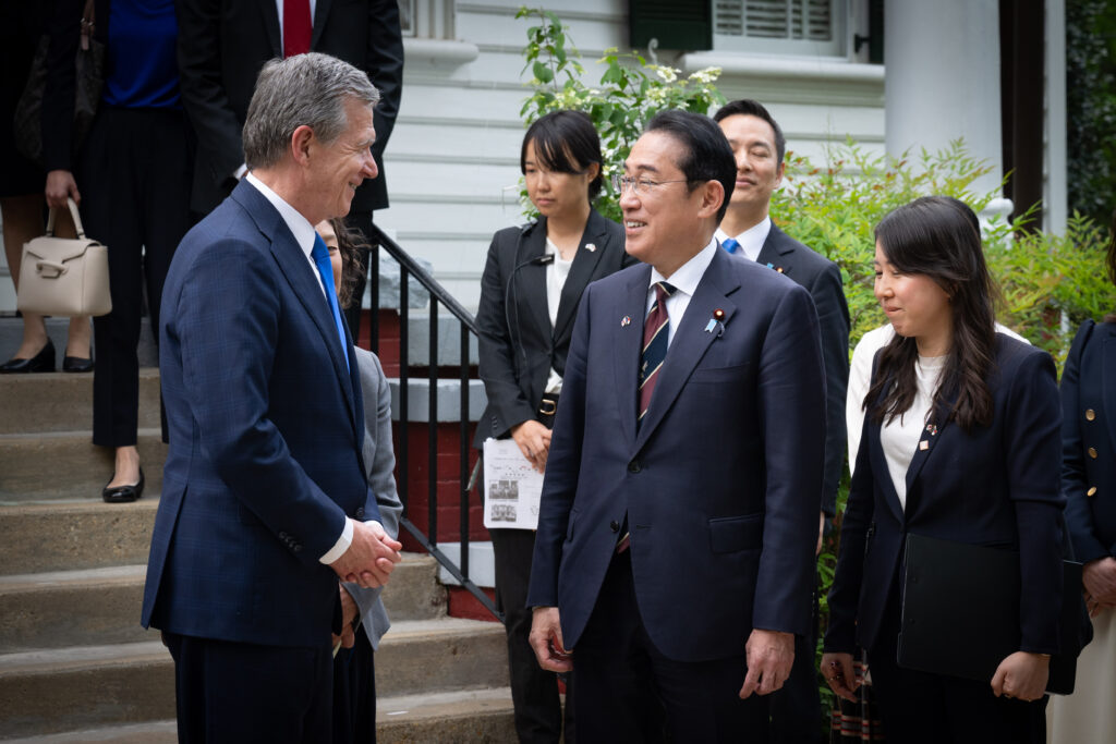 Japanese Prime Minister Fumio Kishida shaking hands with Governor Roy Cooper