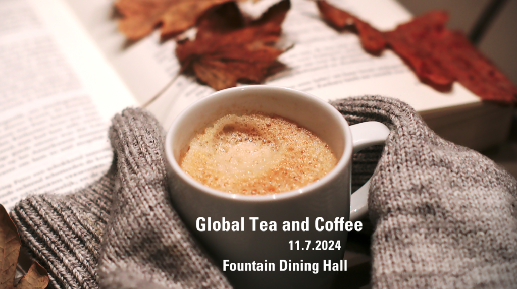 An image of a cup of coffee with sweater covered hands holding the cup next to a book with autumn leaves on top.