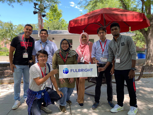 An image of Fulbright Students holding a sign that says "Fulbright."