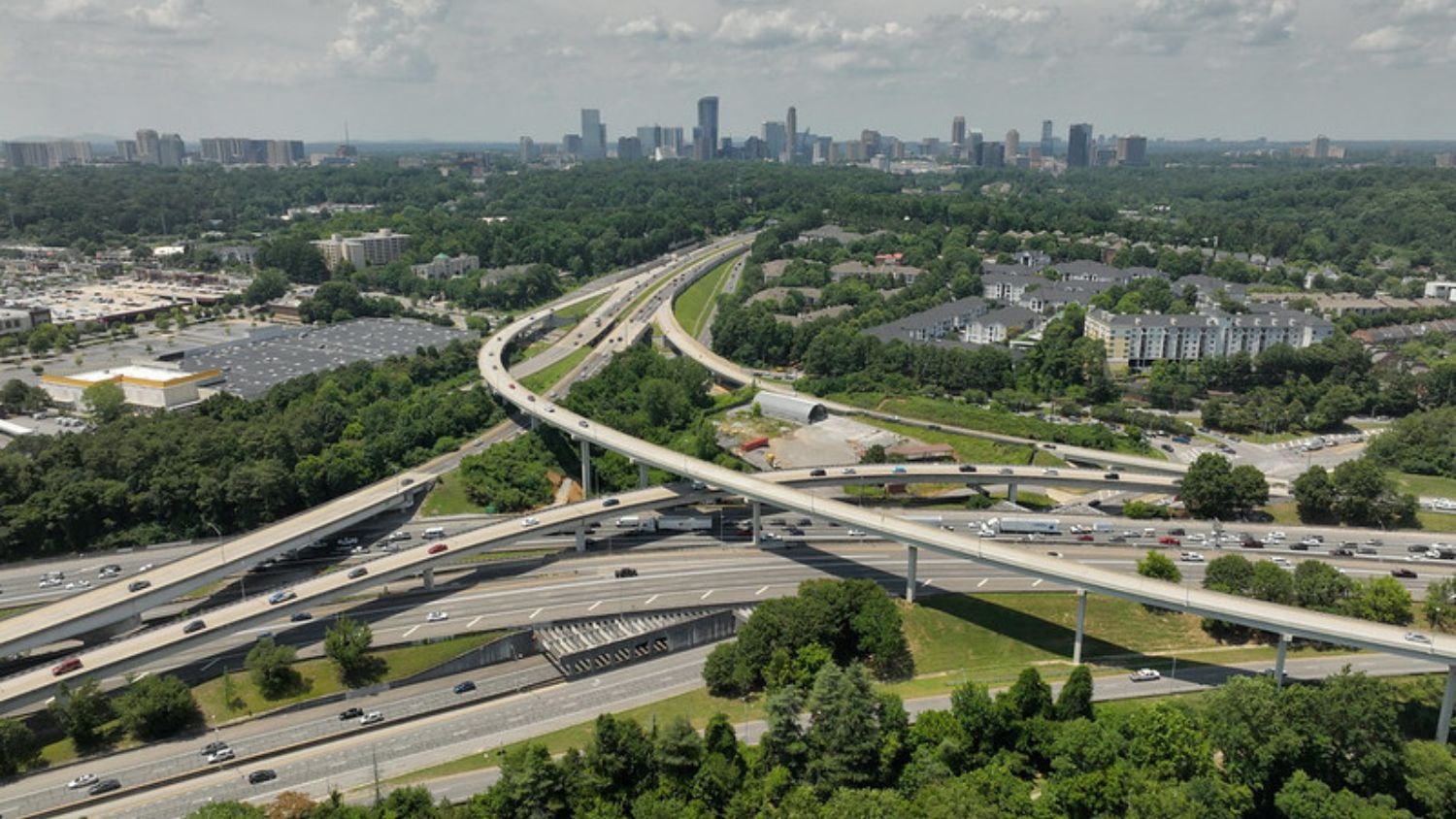 An image of the Raleigh skyline and highway system from a drone perspective.