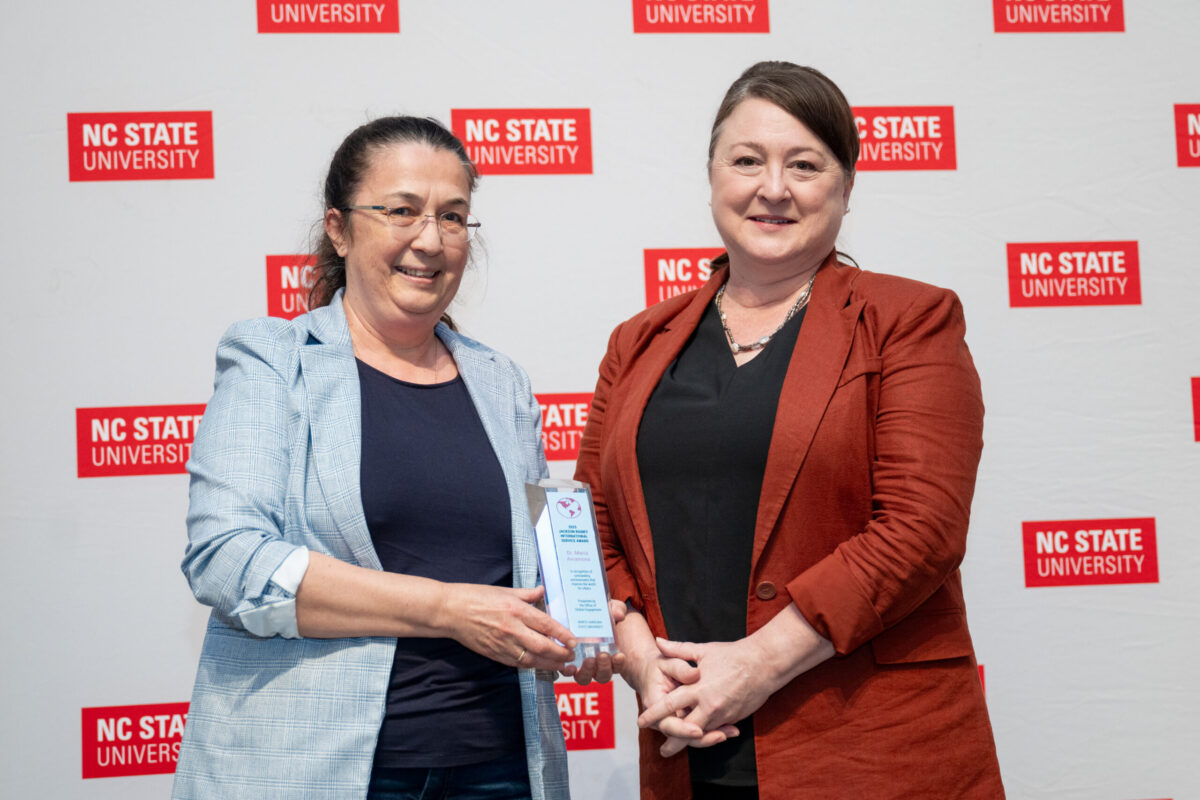 Vice Provost Amy Conger poses with a faculty member and their award.