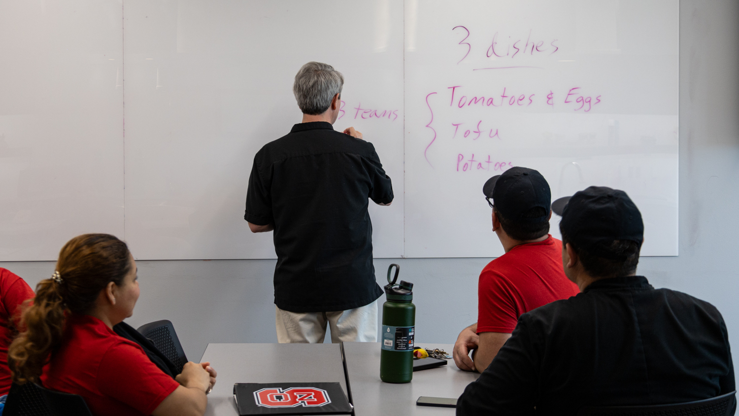 Lead Instructor Dr. Justin Berg instructs students on what recipes they’ll be preparing for the day.