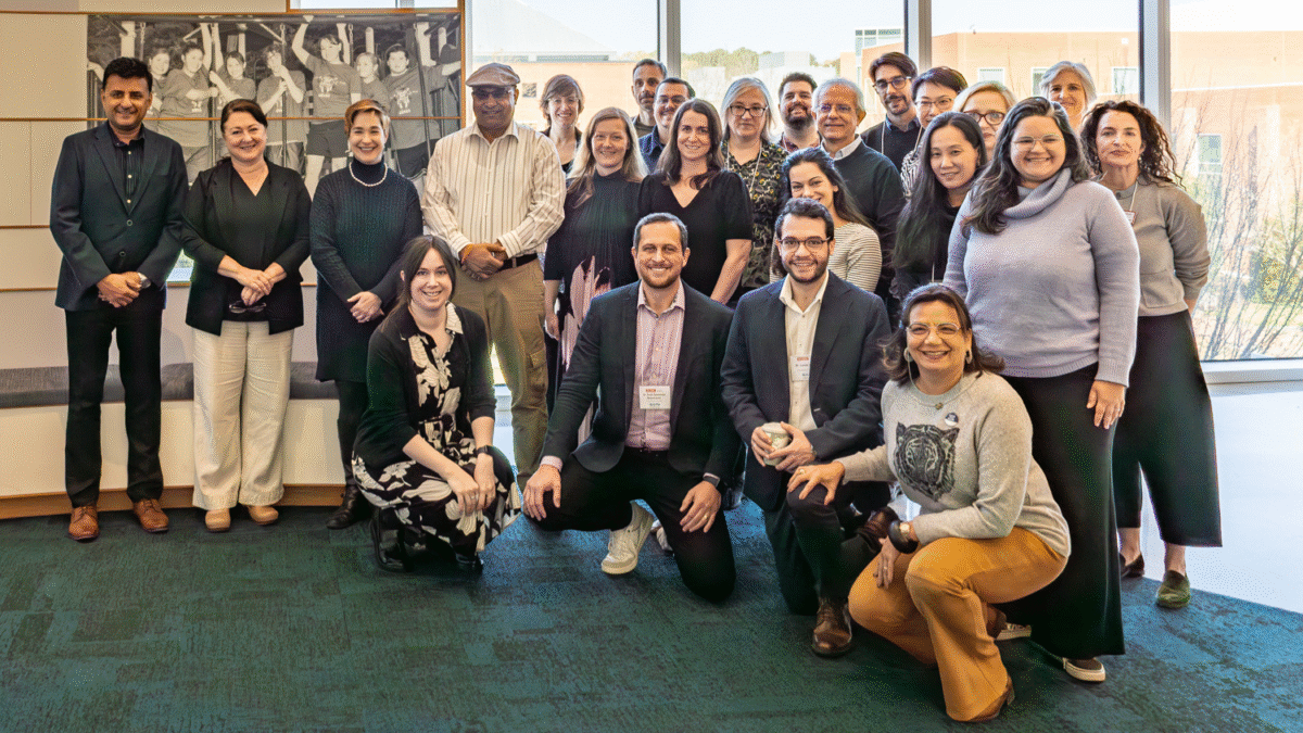UGPN attendees gathered for a group photo in front of a window in Centennial campus.