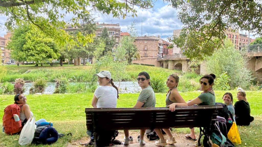 Students stop for a break on their hike at Puente la Reina. 