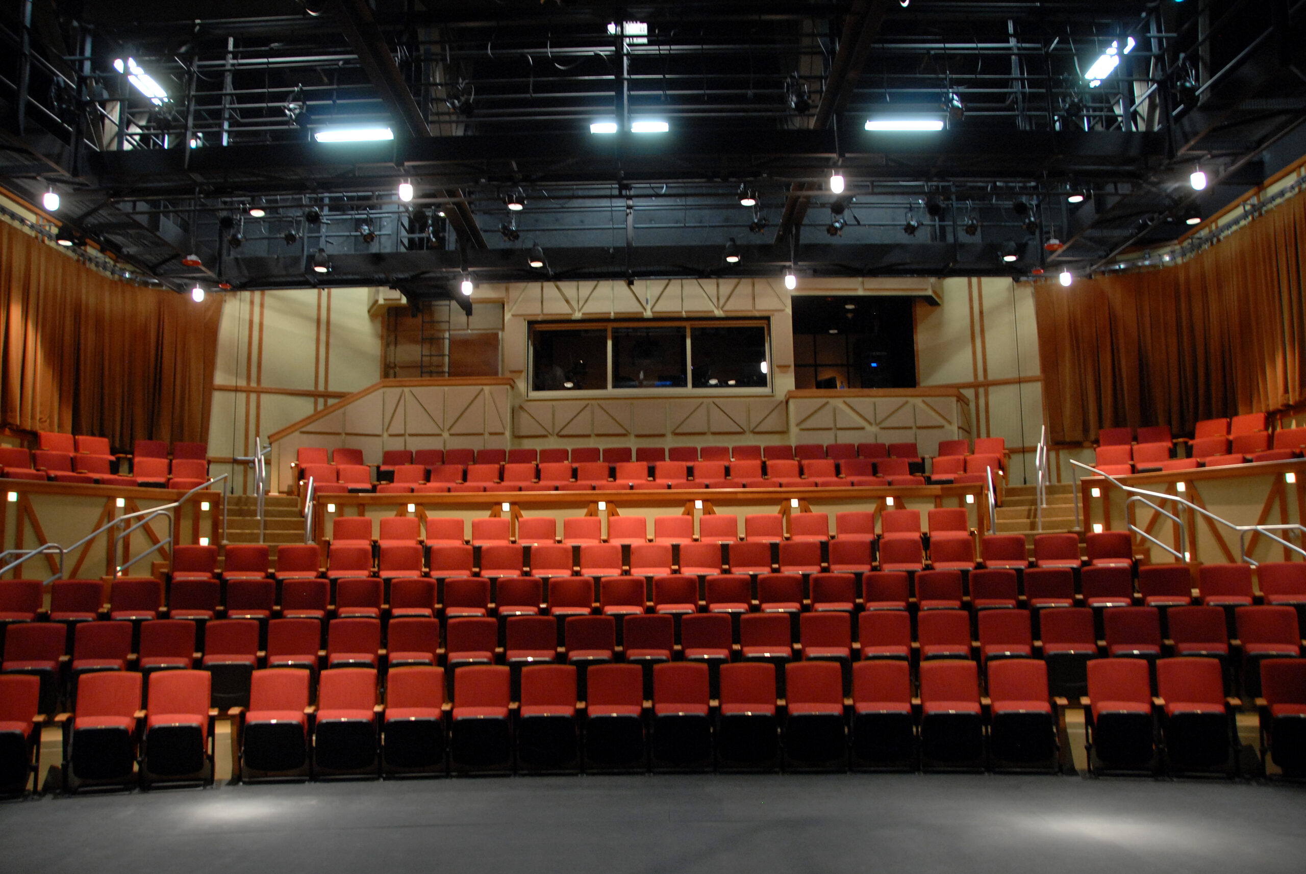 Rows of red theater seats at Thompson Theatre.