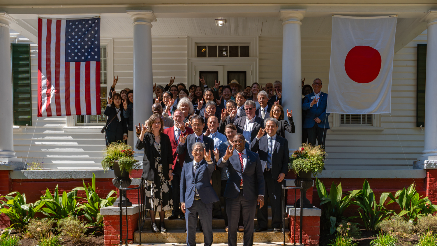 Chancellor Howell and President Sugiyama show off their Wolfies alongside attendees of the Garden Dedication Ceremony at the NC Japan Center.