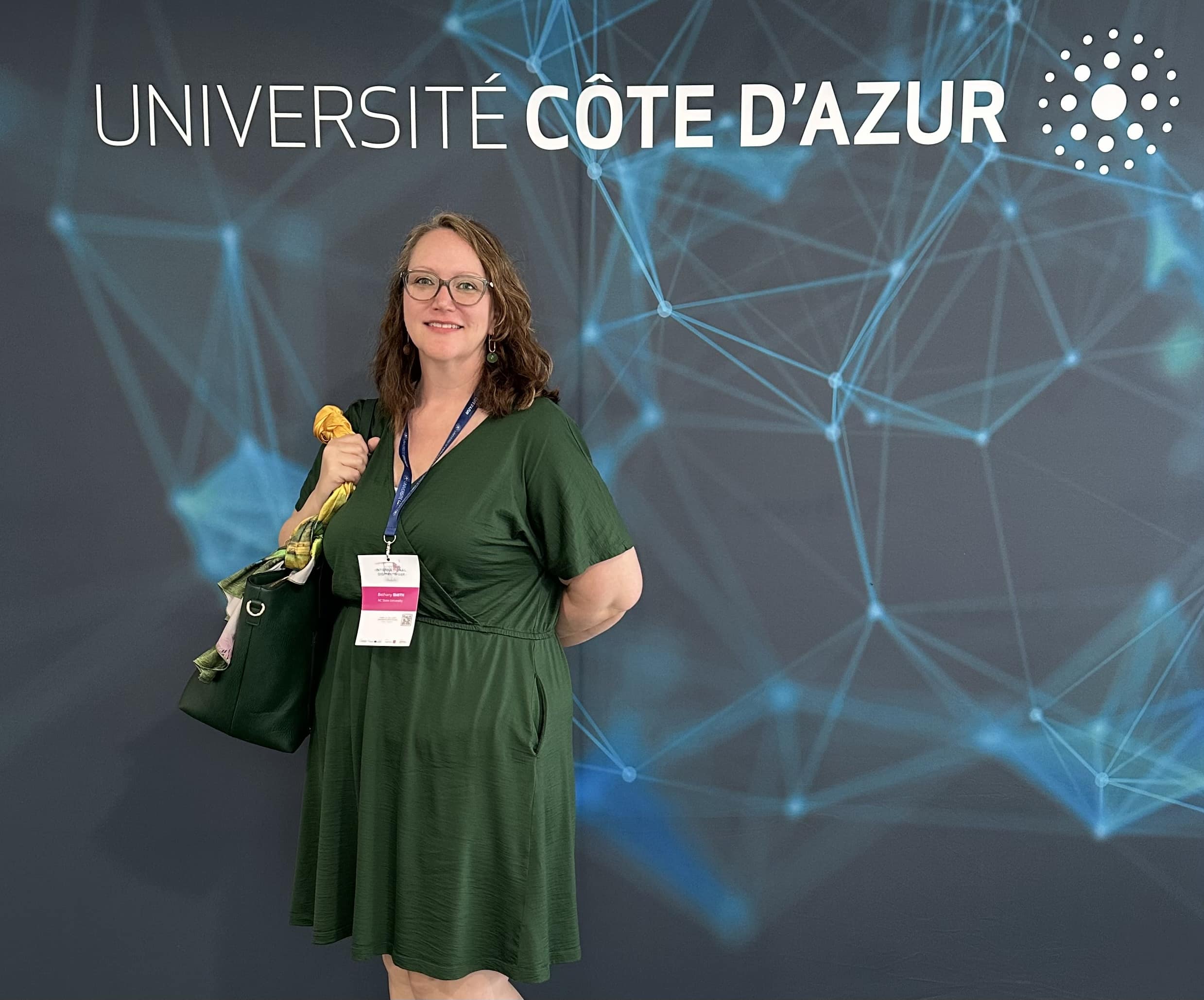 Bethany Smith stands in front of a sign that reads "Universite Cote D'Azur"