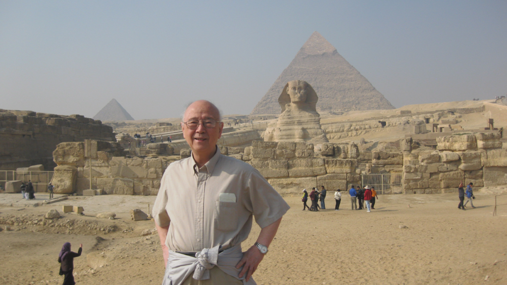 Dr. Pao standing in front of a pyramid.
