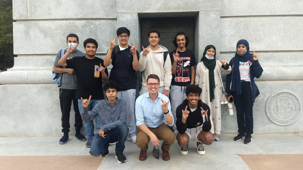 A group of students form Saudi Arabia pose in front of the Belltower.