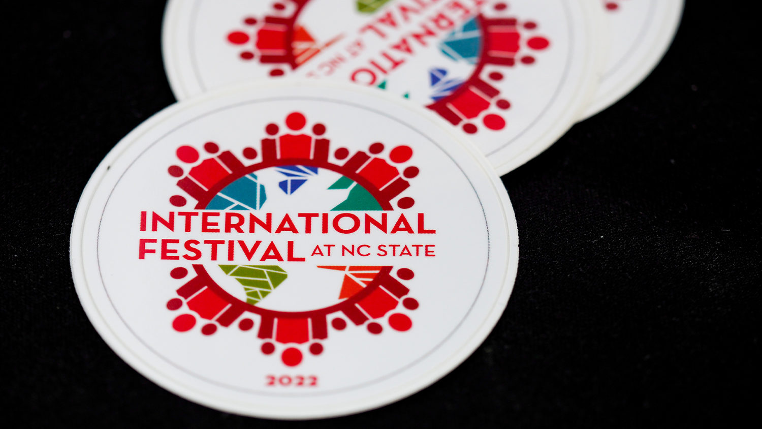 International Festival sticker on black table cloth