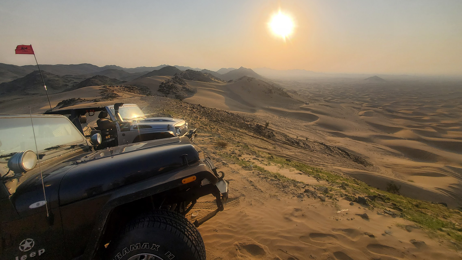 jeeps on top of sand dunes